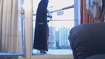 free veiled muslim dancing on the balcony in front of a crane operator free